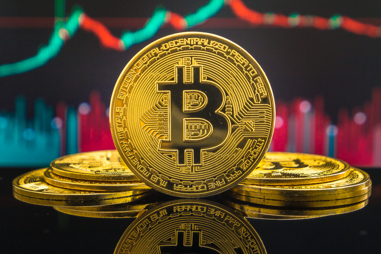 Bitcoin in front of chart | Bitcoin, other crypto fall as US sues Binance; U.S. equities gain as banks stabilize | Markets, BTC - Bitcoin, ETH -Ethereum, CFTC - Commodity Futures Trading Commission, Bank