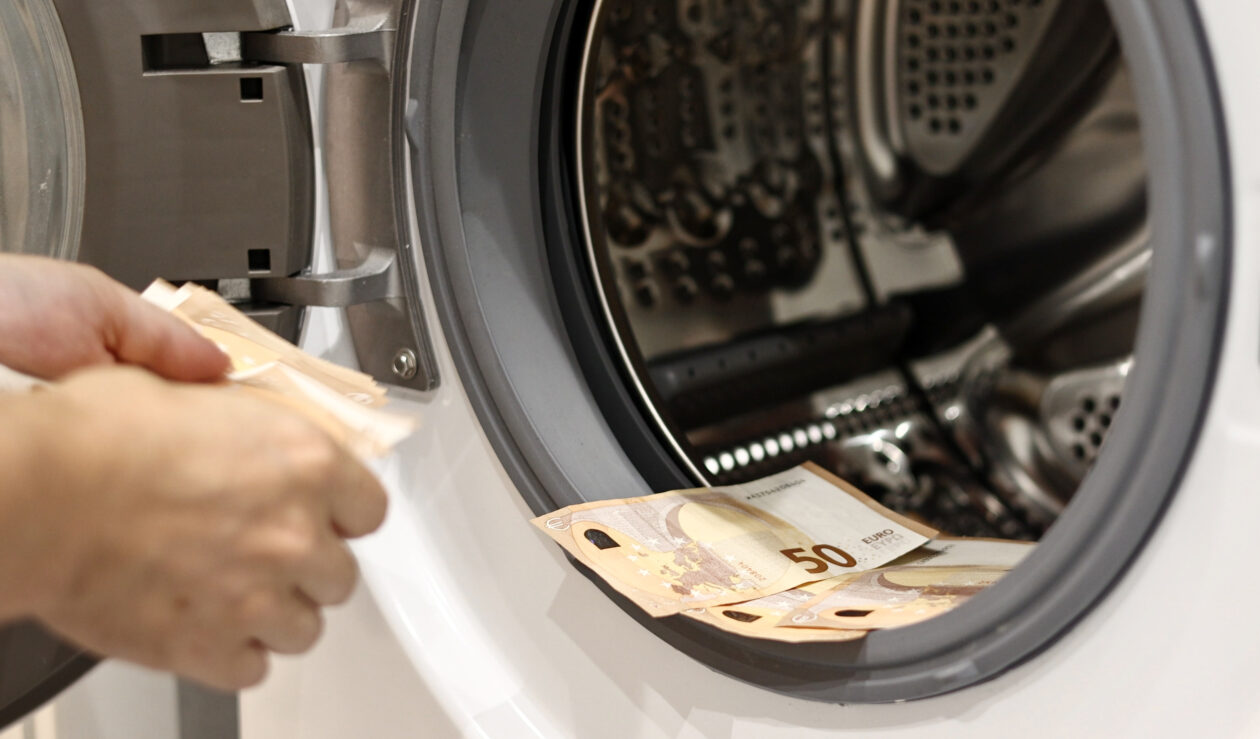 Euro money banknotes in washing machine - illegal cash 50 and mafia money laundering - tax evasion in Europe inflation and impairment. money laundering concept - euro banknotes in washing mashine.