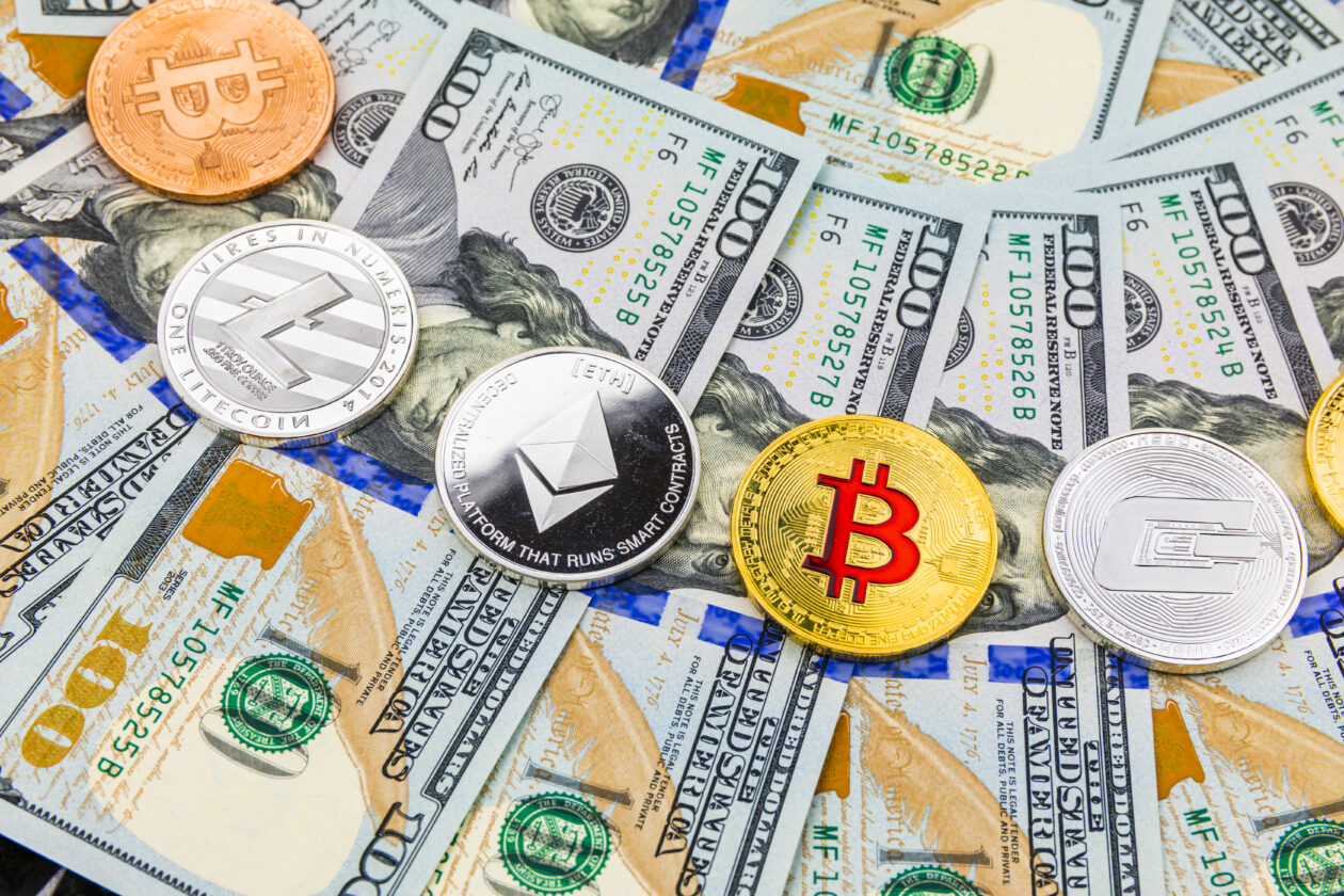 Bitcoin tokens above dollar banknotes