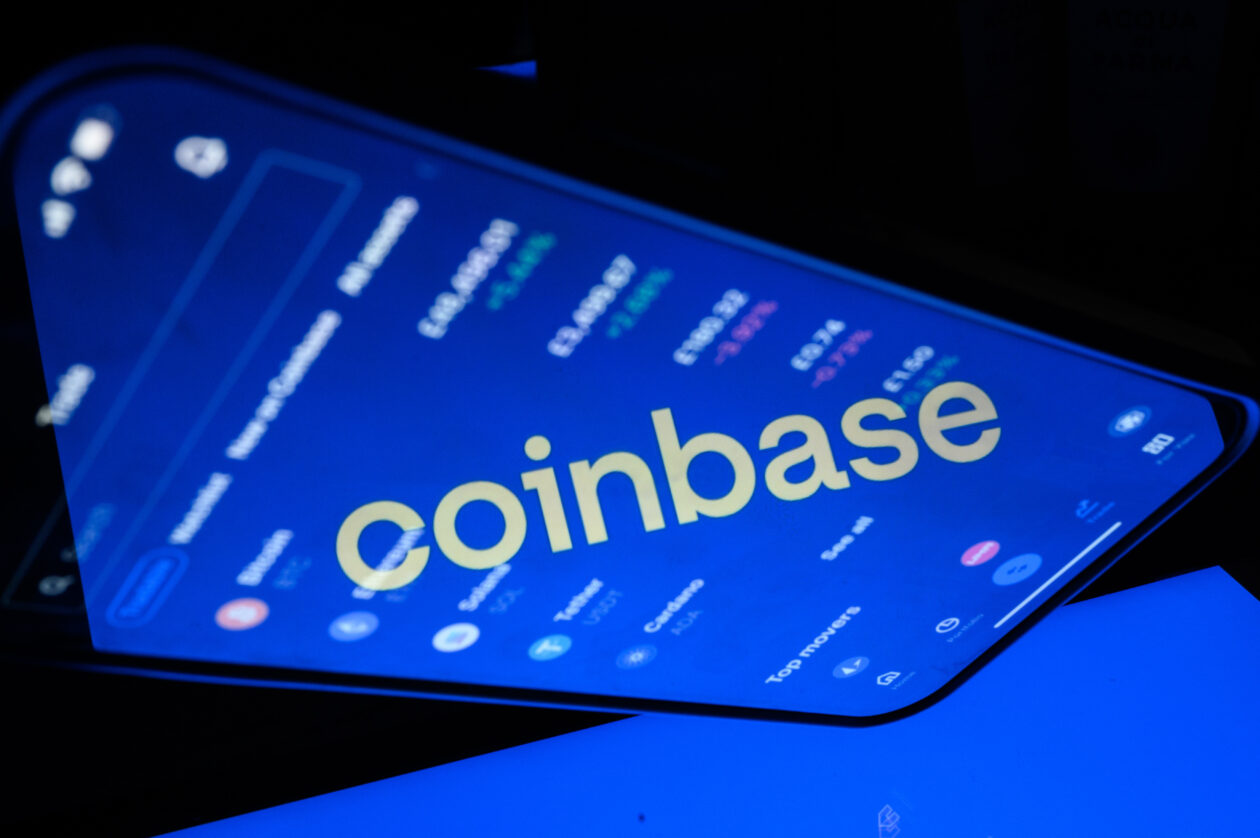Coinbase logo is reflected in a mobile phone screen | Coinbase launches its own blockchain in first for a publicly listed company