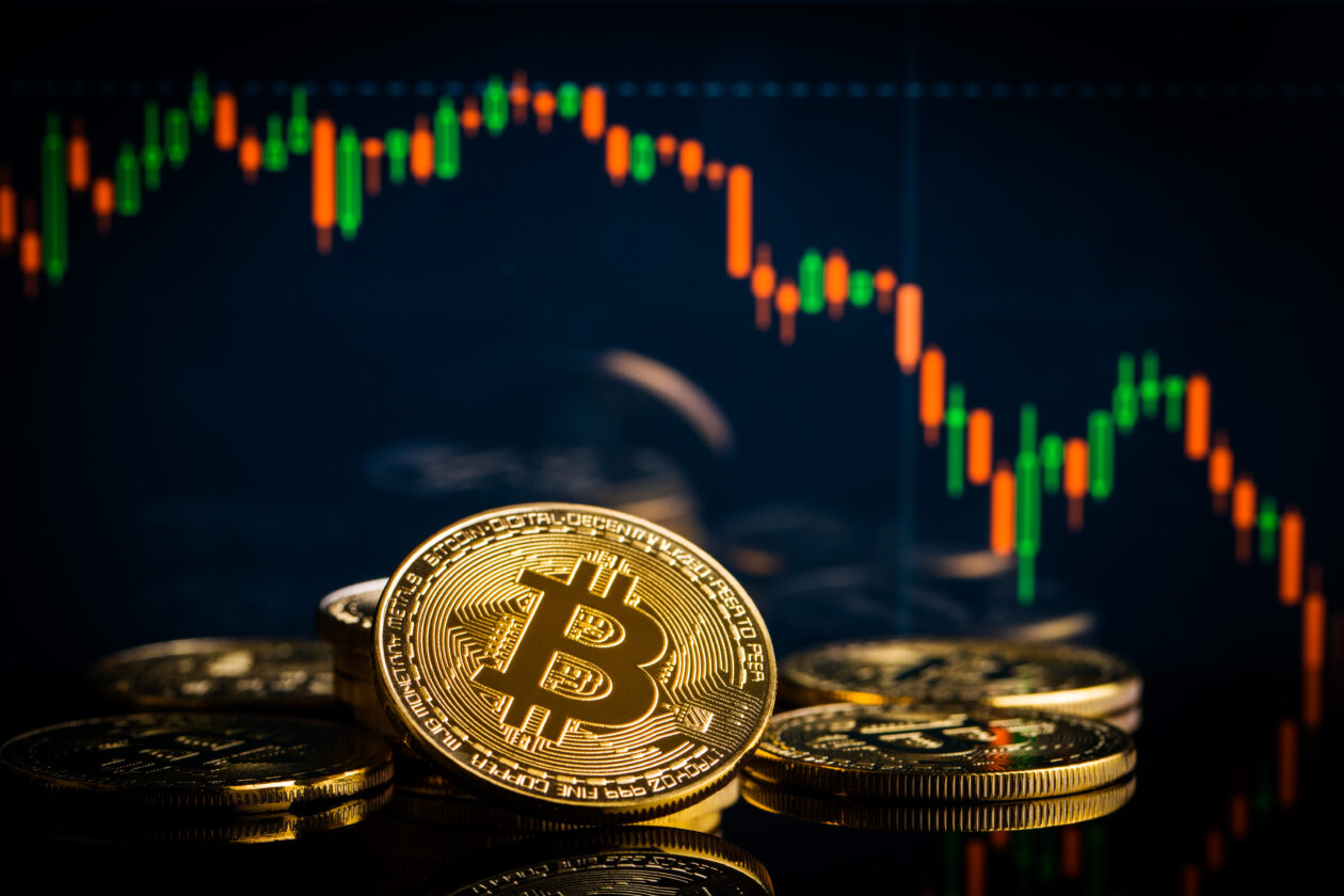 Bitcoin dives to US$28,500; Coinbase buoyed by US futures approval; Fed minutes cast shadow over equities | Concept with bitcoins and falling candle graph.